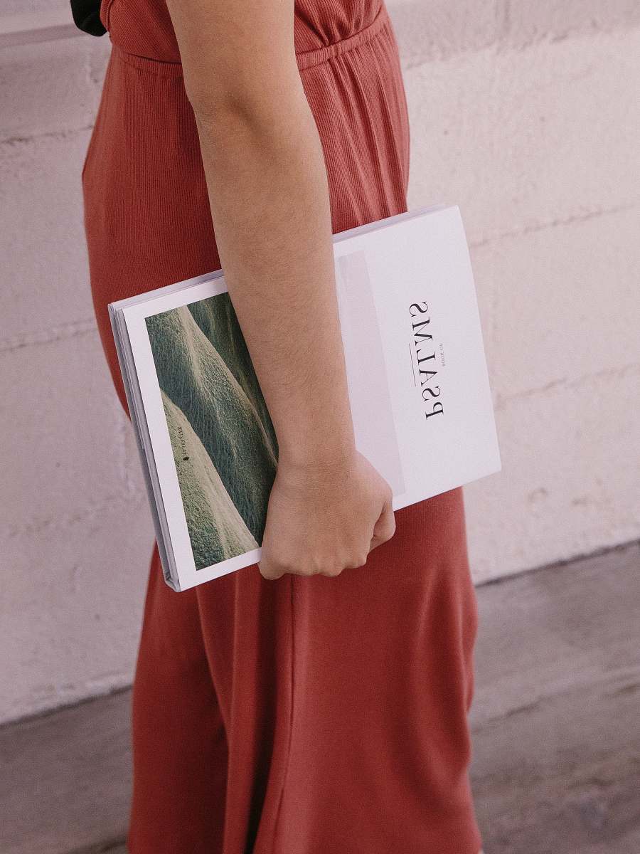 ca woman wearing red jumpsuit holding Psalms book usa